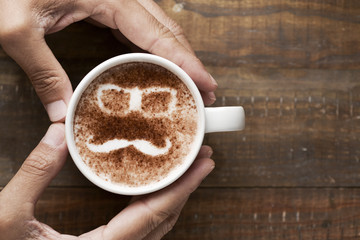 man face in a cup of cappuccino