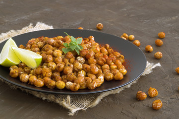 Roasted spicy chickpeas on a rustic background.