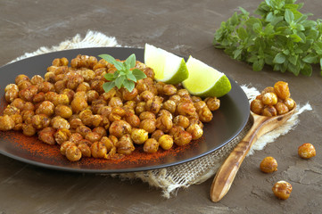 Roasted spicy chickpeas on a rustic background.