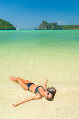 Woman relaxing on the beach in Koh Phi Phi Don in Thailand