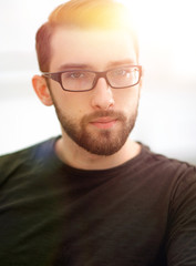 Pleasant guy is resting on sofa