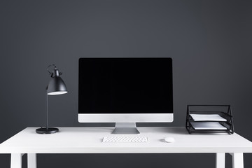modern desktop computer with blank screen, keyboard and computer mouse on table