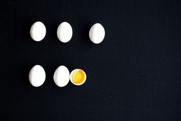White eggs on black background 