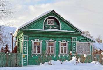 wooden house of green color in the Russian outback