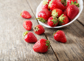 Ripe red strawberries on wooden table