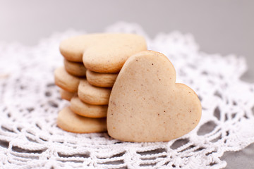 cookies in the shape of heart on a gray background, minimalism, concept of cooking, baking, symbol of love