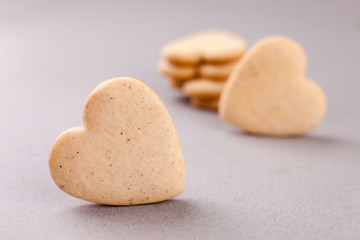 cookies in the shape of heart on a gray background, minimalism, concept of cooking, baking, symbol of love