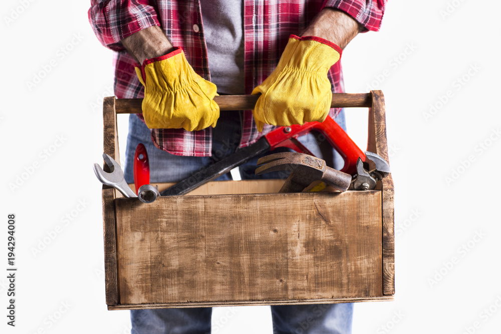 Wall mural isolated in white handyman with toolbox / portrait of a handyman with essential tools