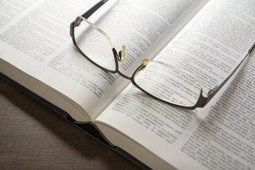 Eyeglasses on an opened text book