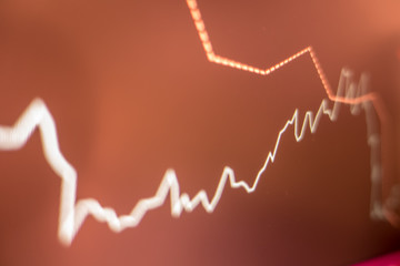Stock exchange market graph analysis in red background
