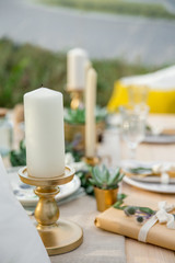 Candle on a gold candlestick. 