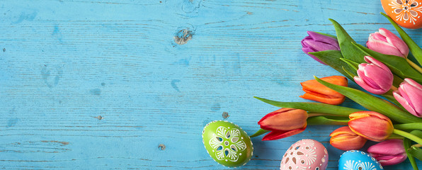Tulip flowers and Easter Eggs on blue background