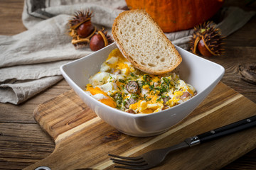 Scrambled eggs with sausage and bread.