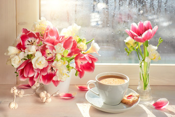 Coffee cup, pink tulips and white freesia - on the window board, springtime background