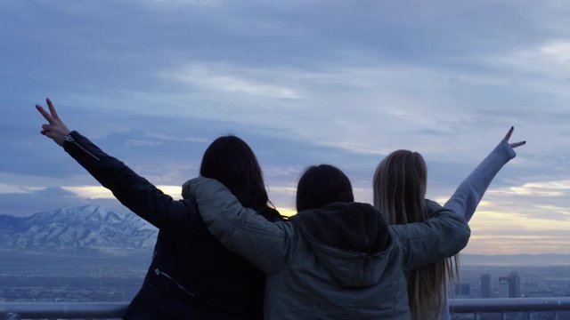Group Of Friends Look Out At City Views At Sunset, Arms Around Each Other, Girls On The End Hold Up Peace Signs - Shot On Red Scarlet-W Dragon In 4K/ Slow Motion