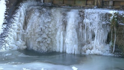 River brook waterfall with frozen ice snow and icicles - Powered by Adobe