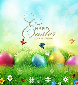 Vector illustration. Easter greeting card with colorful eggs lying on the green grass against the blue sky. Design element, greeting card template