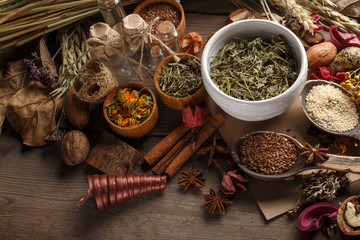 Bunch of healing herbs on wooden board. Herbal medicine. Top view.