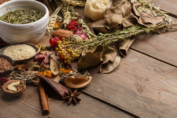 Bunch of healing herbs on wooden board. Herbal medicine. Top view.