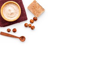 Natural cosmetics for skin care. Body scrub with hazelnut. White background top view copy space