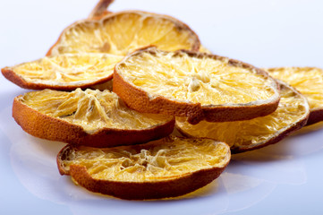Dried orange and lemon slices on wooden background. rings of dried citrus on table.
