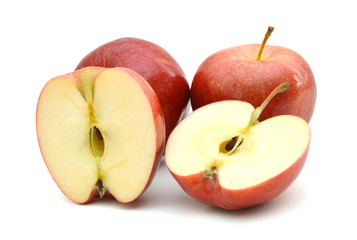 Two ripe red apples and half of apple. Isolated on a white background.