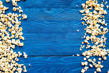 Popcorn background on blue top view copy space