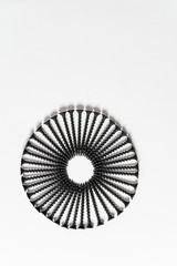 Wonderful circle of black screws, set one by one, isolated on a white background