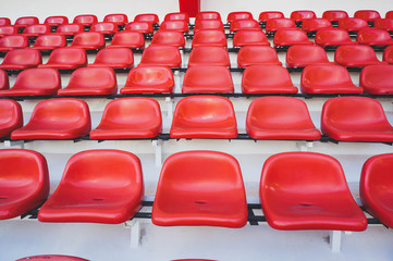 row of red seat at public sport stadium .