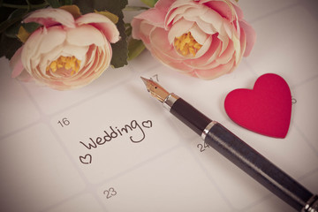 Reminder Wedding day in calendar planning and fountain pen with color tone.