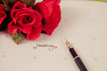 Reminder Wedding day in calendar planning and fountain pen with color tone.