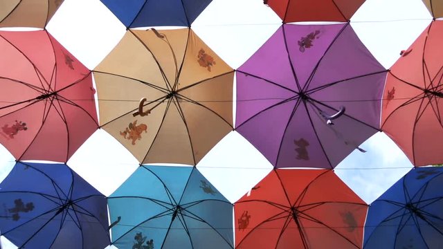 Umbrellas cover the sky from the hot sun