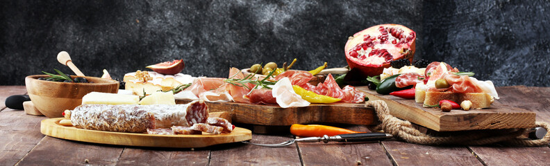 Italian antipasti wine snacks set. Cheese variety, Mediterranean olives, pickles, Prosciutto di...