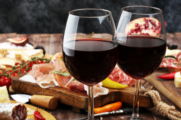 Italian antipasti wine snacks set. Cheese variety, Mediterranean olives, pickles, Prosciutto di...