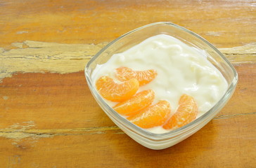 yogurt topping orange scooping on spoon in glass cup