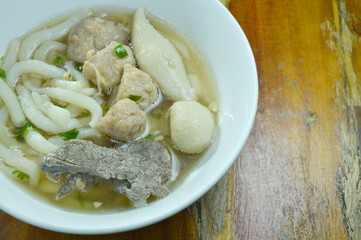 Chinese rice flour noodles topping minced pork and liver with fish ball in soup on bowl