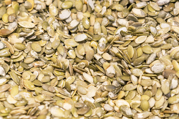 Macro background texture of green pumpkin seeds