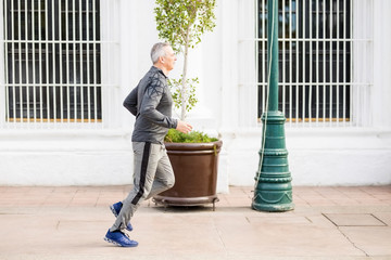 Middle aged hispanic man on morning run in city