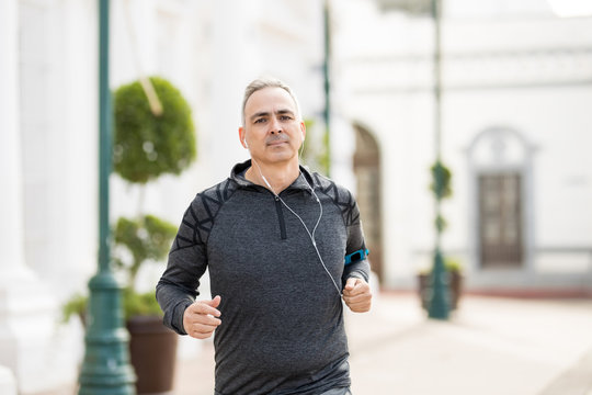 Healthy middle age man jogging in the city