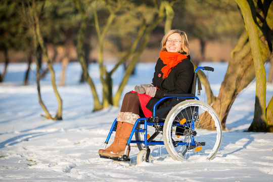 happy young adult woman on wheelchair
