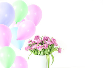 Bouquet of pink tulips in bucket with lot pink air balloons. Fresh spring easter flower. White background , copy space. Greeting card