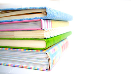 pile of books and notebooks on the white isolated background
