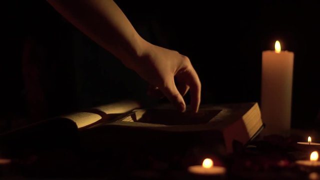 Slider shooting on the book a cache and a skull with candles