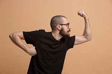 The young emotional angry man on pastel studio background