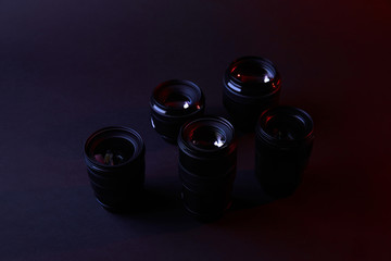 one optical lens on dark surface