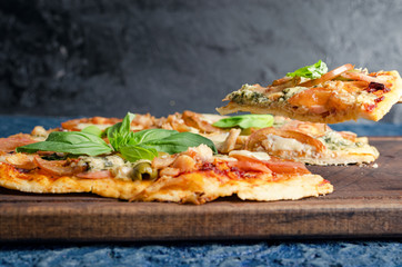 Pizza slice with tomato, chicken and blue cheese