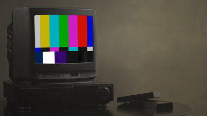 TV test card with rainbow bars, geometric signals. Retro hardware 1980. Glitch art show static error, broken transmission