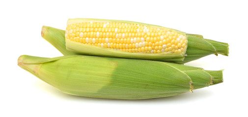 fresh corn fruits with green leaves isolated on white background
