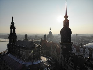 4K Aerial drone shot of sunrise in Dresden inner city with Frauenkirche, Hofkirche, Zitronenpresse with beautiful sun reflections and Elbe river