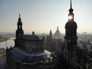 4K Aerial drone shot of sunrise in Dresden inner city with Frauenkirche, Hofkirche, Zitronenpresse with beautiful sun reflections and Elbe river